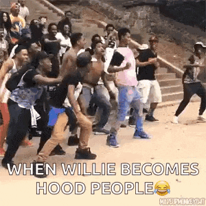 a group of young men are dancing in a crowd on the street .