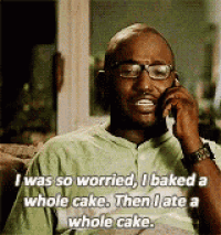 a man with glasses is talking on a cell phone .