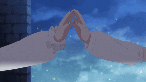 a couple of hands making a heart shape with a blue sky behind them