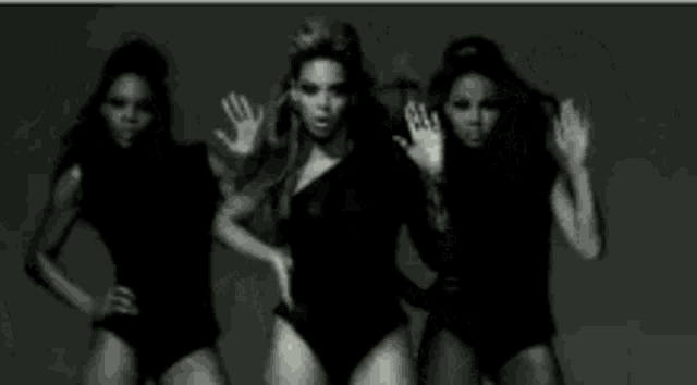 a black and white photo of a group of women dancing .