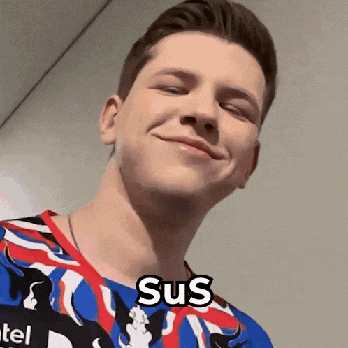 a man wearing a colorful shirt with the word sus on it