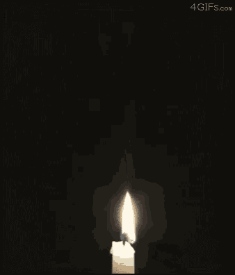 a candle is lit and smoke is coming out of it with the website 4gifs.com in the corner