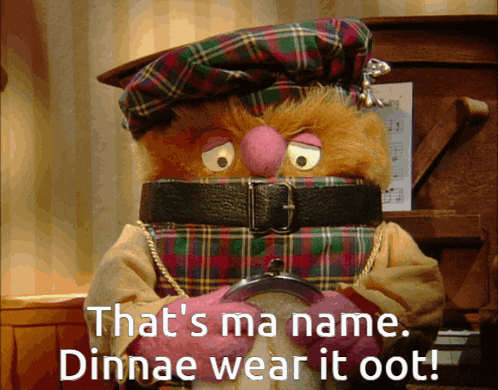 a stuffed animal wearing a kilt and a belt with the words that 's ma name dinnae wear it oot