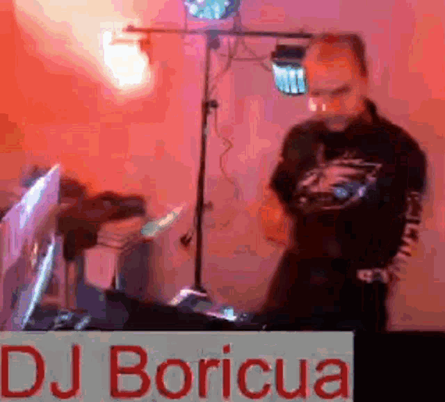a dj named dj boricua is standing in front of a microphone