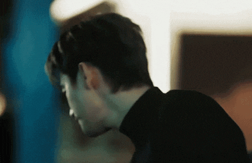 a close up of a man 's head and neck in a black turtleneck .