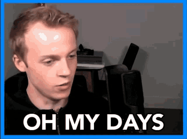 a man in a black hoodie is sitting in front of a microphone with the words `` oh my days '' written above him .
