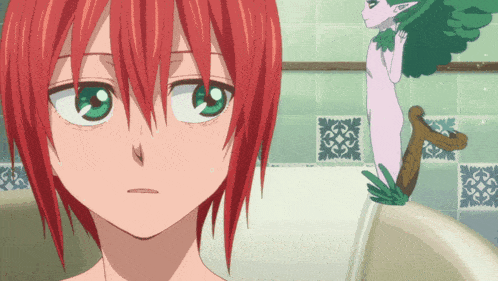 a girl with red hair and green eyes looks at something