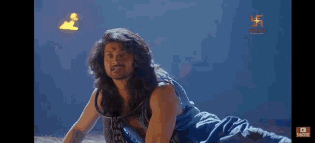a man with long hair and a beard is crawling on the ground