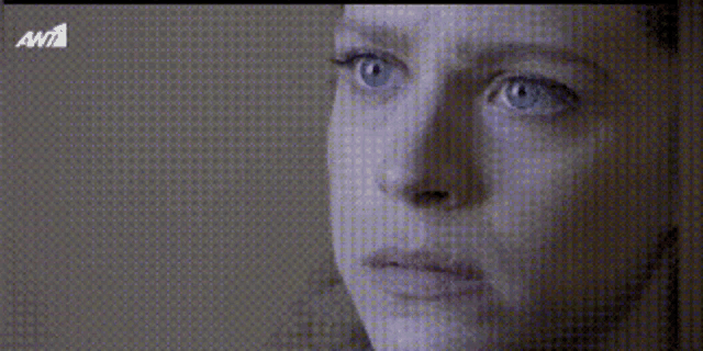 a close up of a woman 's face with ant1 written on the bottom