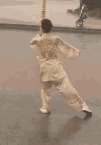 a woman is dancing on a dance floor with a sword in her hand .