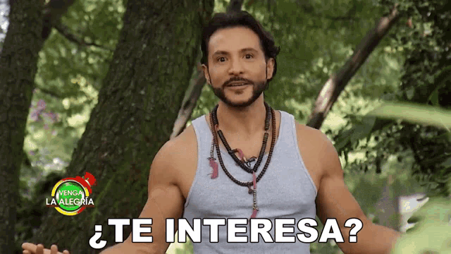 a man in a gray tank top is asking " te interesa "
