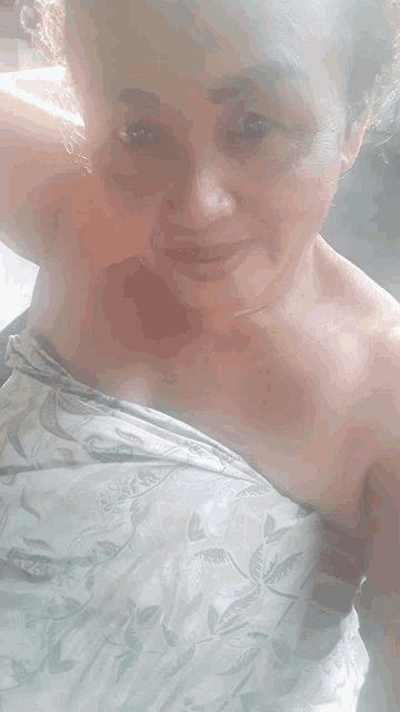 a woman is taking a picture of herself with a floral dress