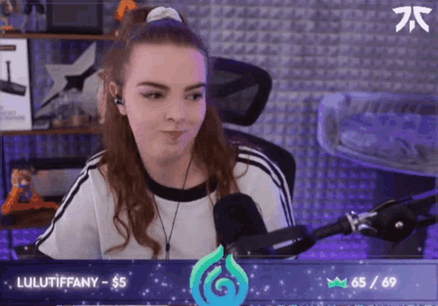 a girl is sitting in front of a microphone with lulutiffany written on the bottom