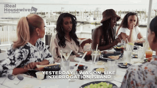 a group of women are sitting at a table with the words " yesterday i was on like interrogation island "