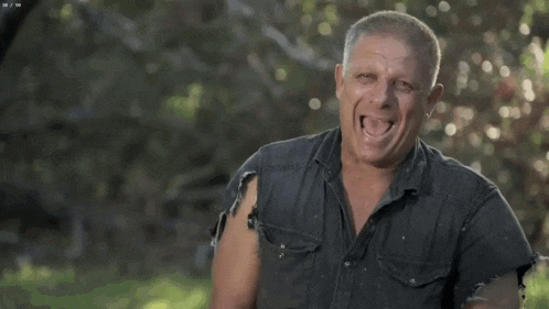 a man in a black shirt is making a funny face with his mouth open