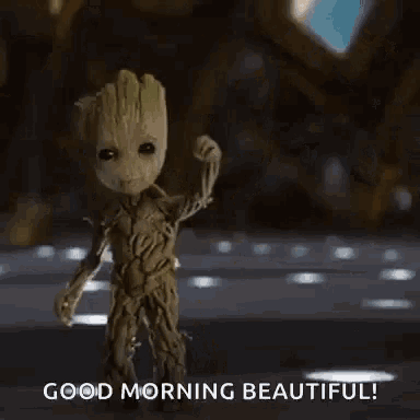 a baby groot from guardians of the galaxy is waving his hand and says good morning beautiful .
