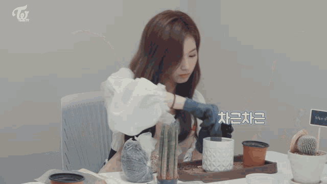 two women sitting at a table with a sign that says twice beauty on it
