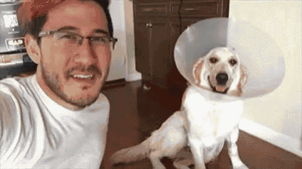 a man is taking a selfie with a dog wearing a collar .