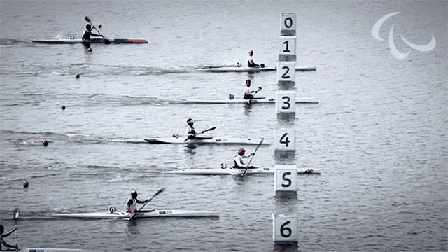 a group of people are rowing kayaks in a race with numbers 0 1 2 3 4 5 6