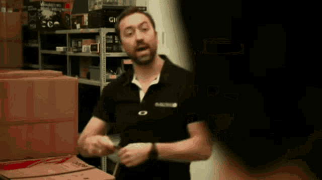 a man in a black shirt with the word oakley on the front