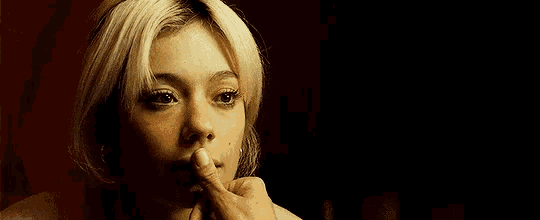 a close up of a woman 's face with blonde hair .