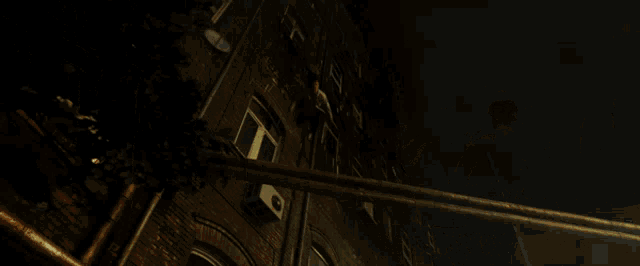 a person laying on the ground in front of a house