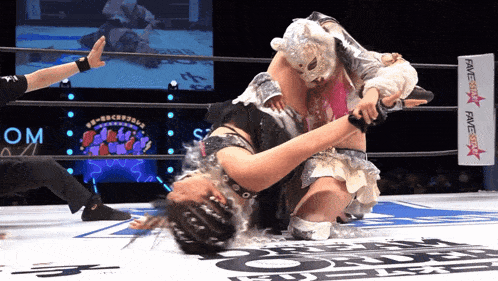 a woman in a wrestling ring with a sign that says fame star on it