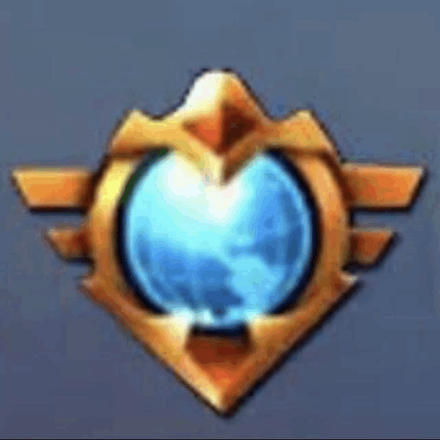 a gold emblem with a blue sphere in the middle .