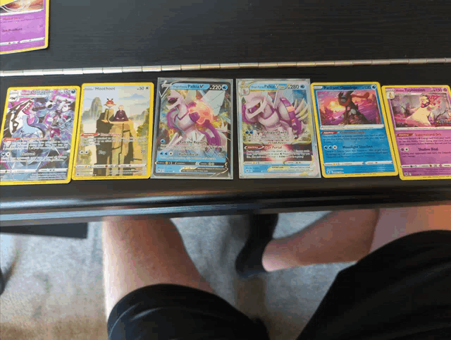 a row of pokemon cards on a table including a card that says psychic power on it