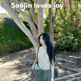 a woman standing next to a tree with the words soojin loves joy written above her
