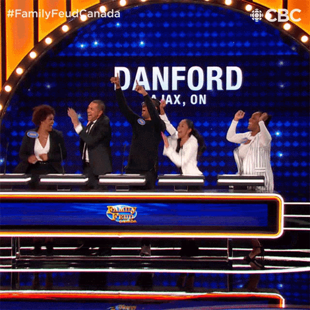 a group of people are standing in front of a screen that says danford
