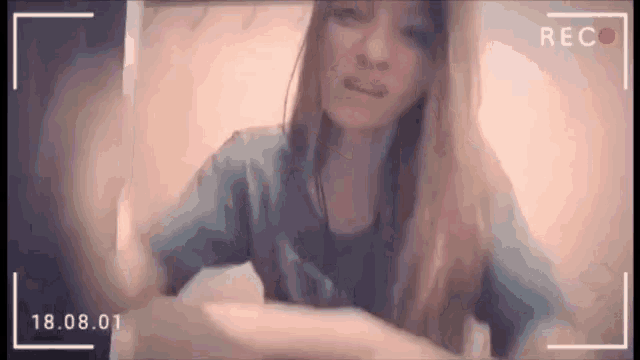 a woman is being recorded on a video camera with the date 18.08.01