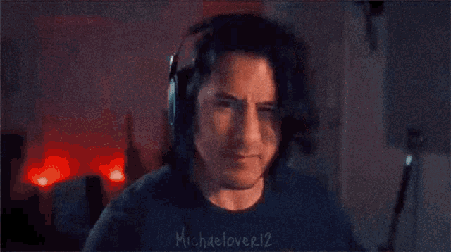 a man wearing headphones and a shirt that says michaellover12 on the sleeve