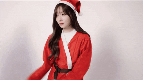 a woman is dressed in a santa claus outfit and hat