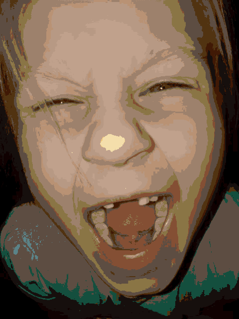 a close up of a child making a funny face with his mouth open