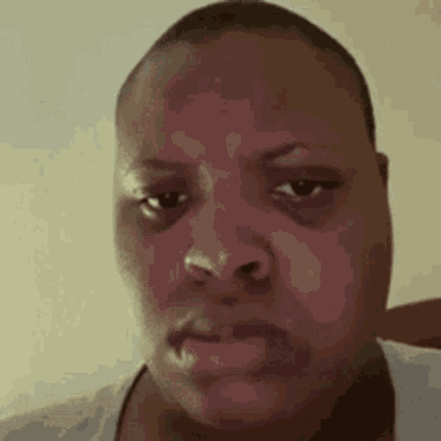 a close up of a person 's face with a sad look on their face .