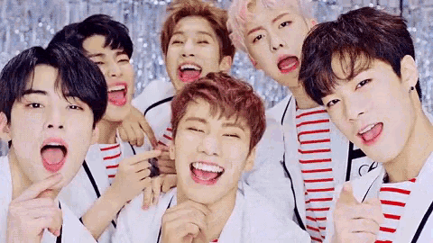 a group of young men are posing for a picture and laughing .