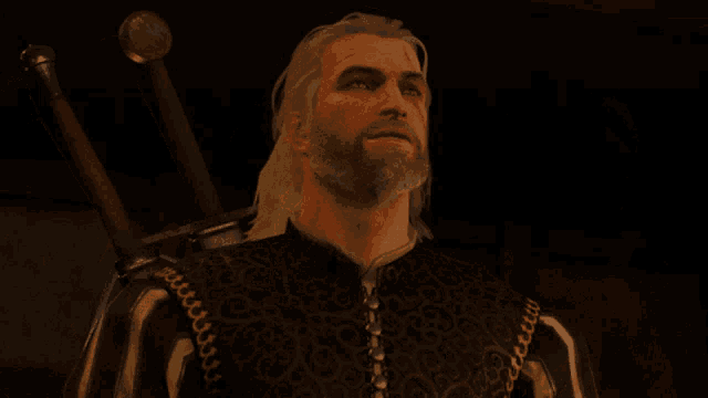 a man with a beard is wearing a black and white shirt with chains on the sleeves