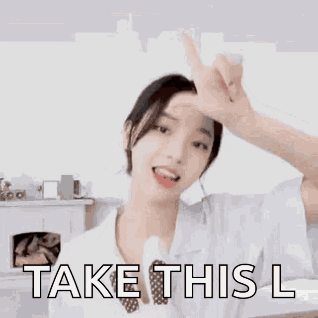 a woman is making a peace sign with her hand and the words `` take this l '' .