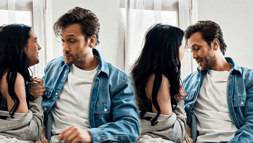 a man and a woman are sitting on a bed and talking to each other