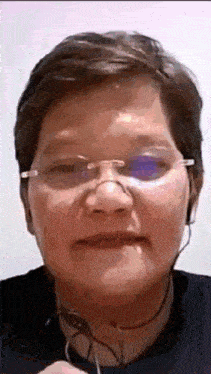 a close up of a woman wearing glasses and headphones .