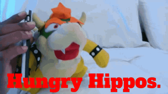 a hungry hippos advertisement with a stuffed animal in the foreground