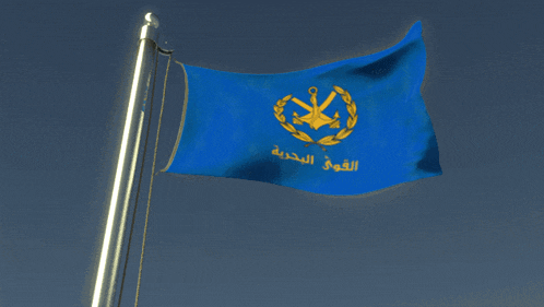 a blue flag with a gold anchor on it is flying in the wind