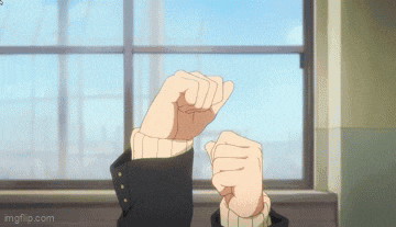 a person is making a fist in front of a window