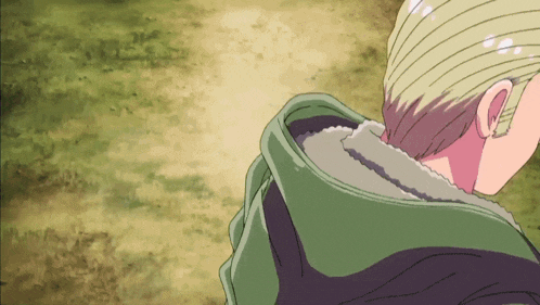 a close up of a person 's head with a green hood