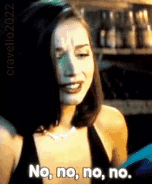 a woman in a black dress is saying no no no no .