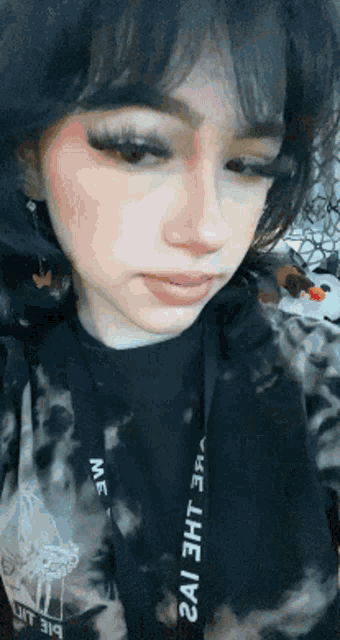 a close up of a girl wearing a tie dye hoodie with the word me on it