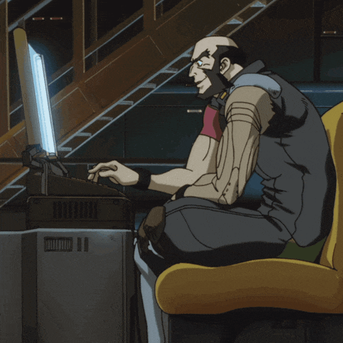 a man is sitting in front of a computer with a light shining on him