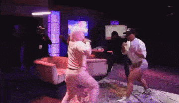 a man and a woman are dancing in a room with a sign that says exit