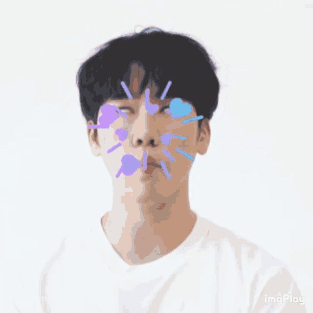 a man making a funny face with hearts surrounding his head